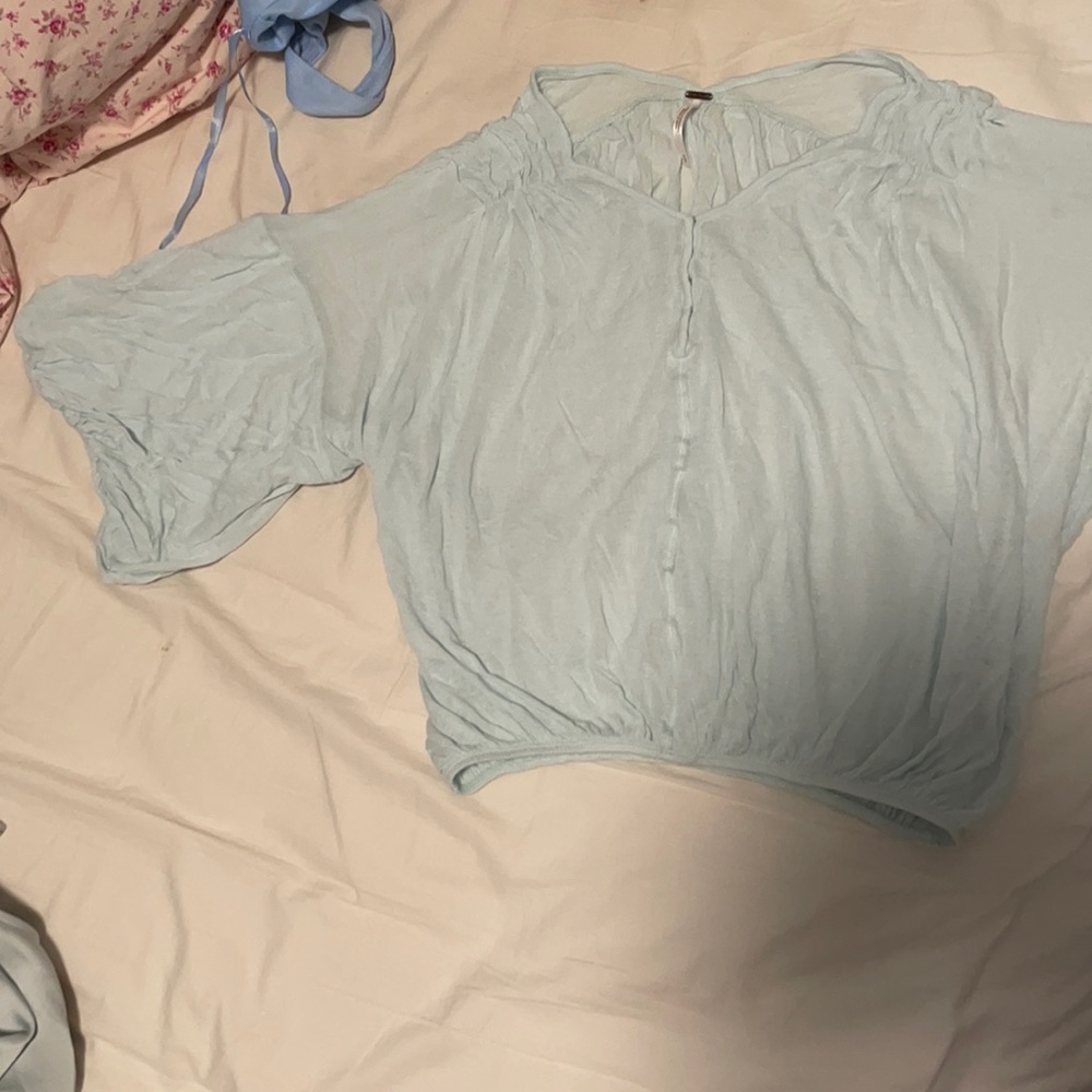 Turquoise blue. Flowy top from Free People. No stains. Material is sheer